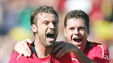 Fernando Rech celebrates with Adelaide team-mate Carl Veart after scoring a goal.