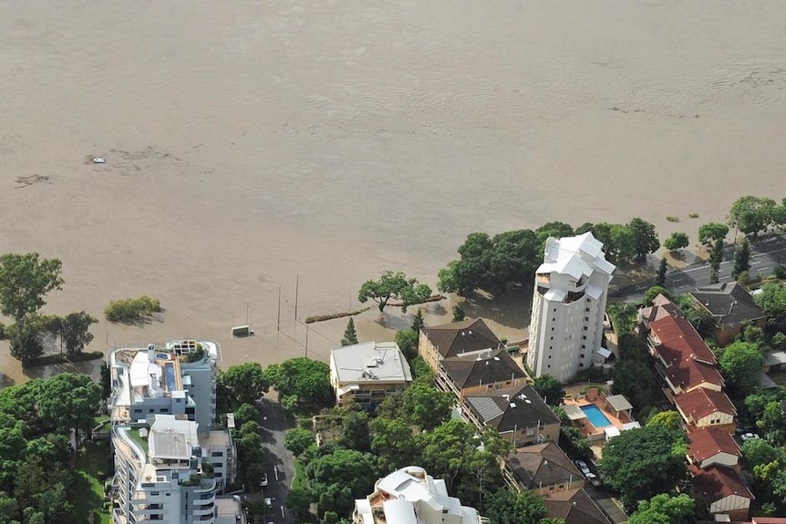 Floodwaters cross over Coronation Drive near Toowong in Brisbane on January 12, 2011.