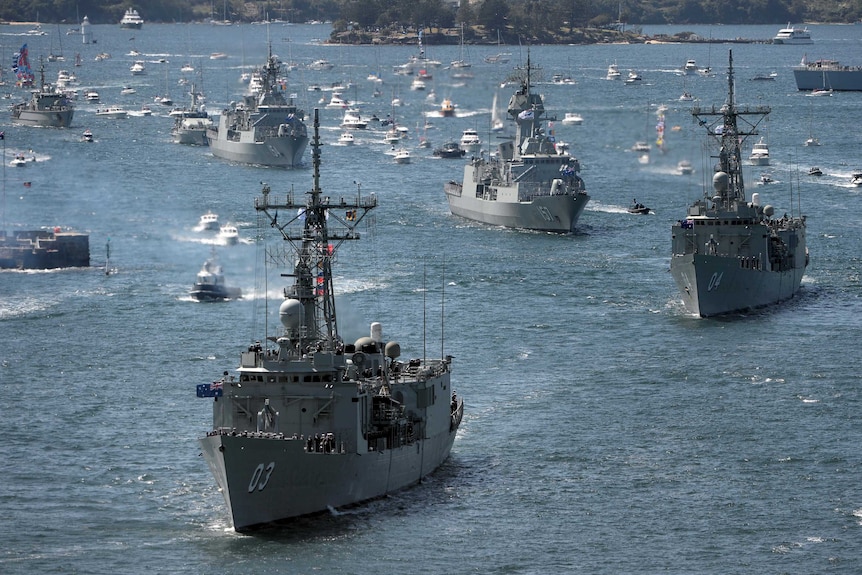 The HMAS Sydney leads the ceremonial fleet into Sydney Harbour.