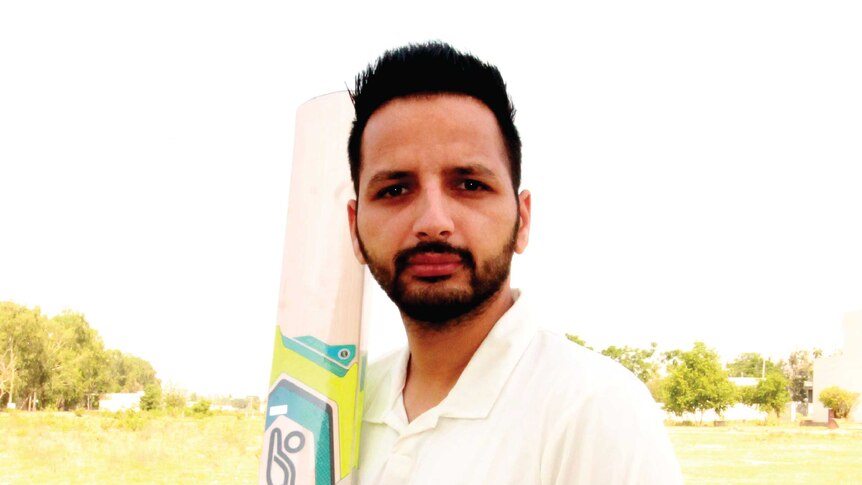 Baljinder Sandhu holds a cricket bat