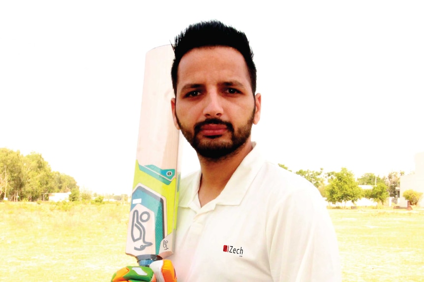 Baljinder Sandhu holds a cricket bat