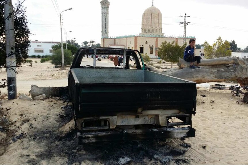 A burned truck is seen outside Al-Rawda Mosque in northern Sinai