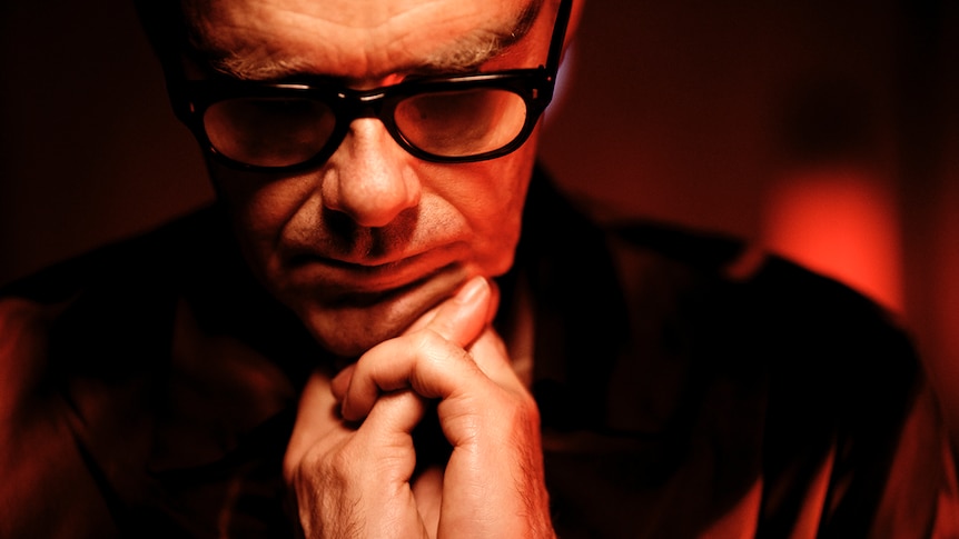 Close up of Neil Barnes from Leftfield, looking down with his head in his hands
