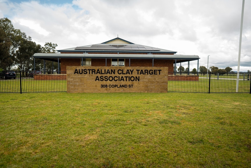 A sign outside a building says 'Australian Clay Target Association'.