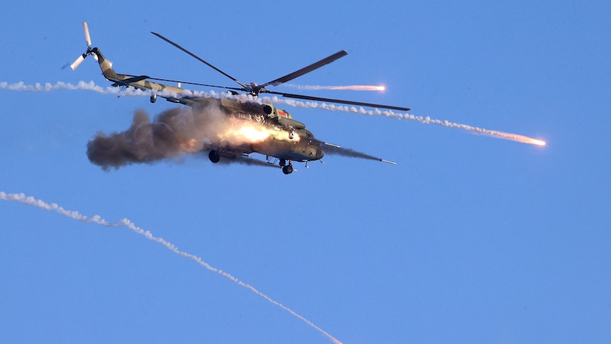 A military helicopter fires flying over the Gozhsky training ground during Russia-Belarus military drills.