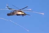 A military helicopter fires flying over the Gozhsky training ground during Russia-Belarus military drills.