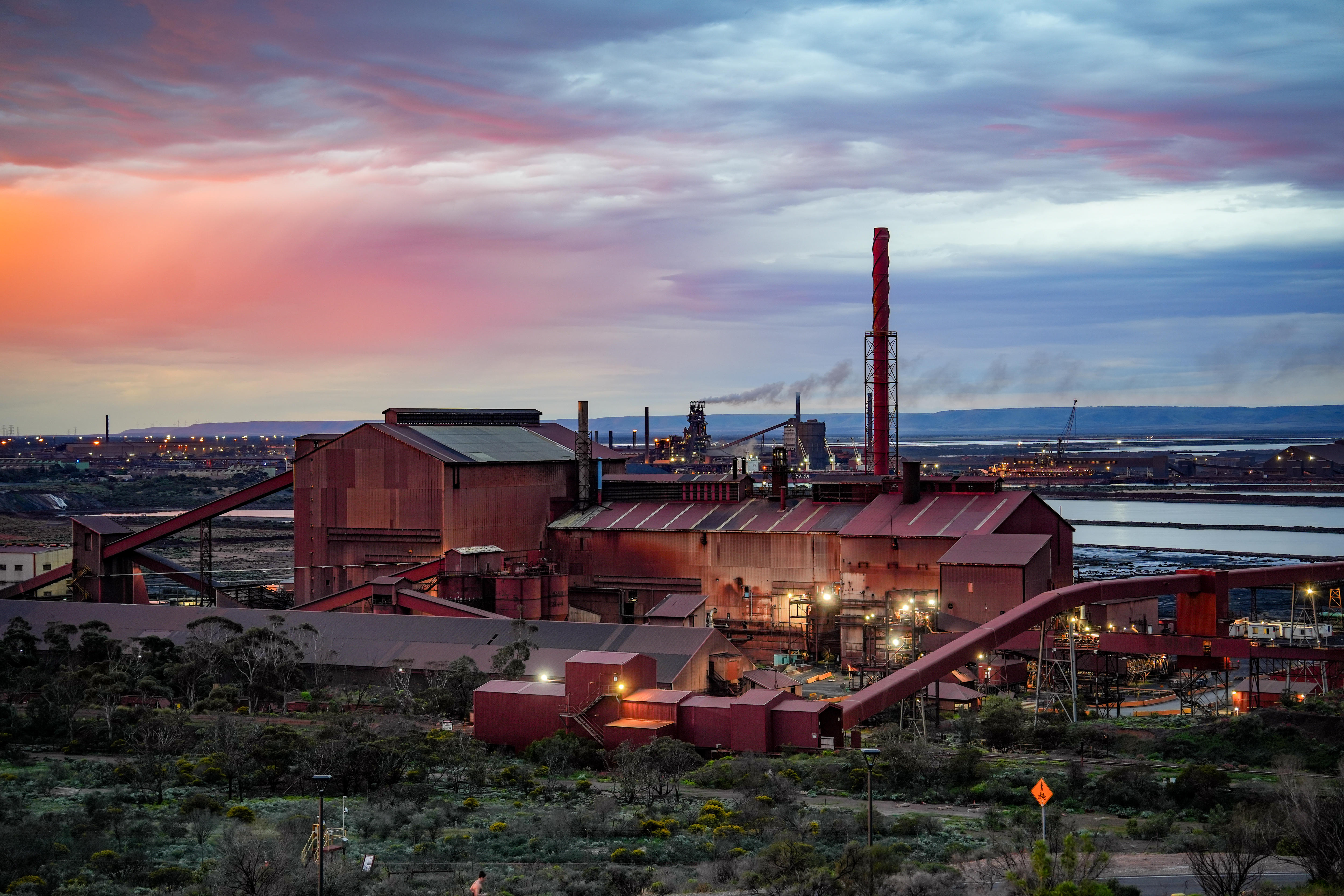 An industrial site next to the ocean.