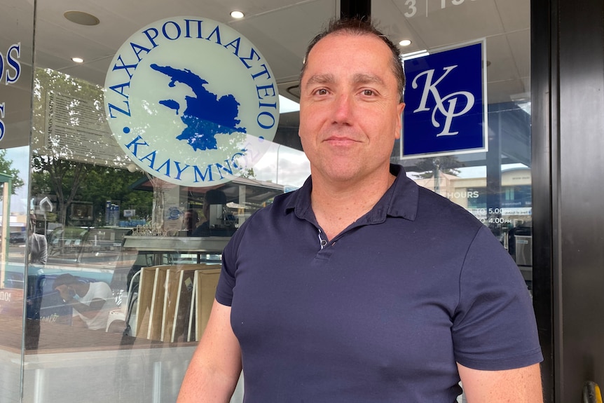 A man standing in front of a shop