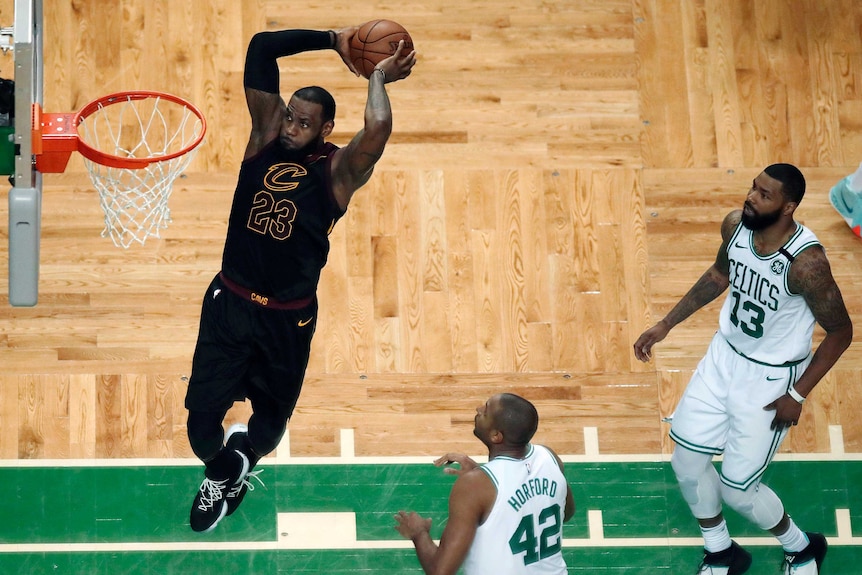 Cleveland Cavaliers' LeBron James dunks in front of Boston Celtics in NBA East finals game seven.