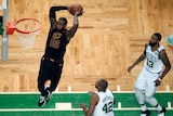 Cleveland Cavaliers' LeBron James dunks in front of Boston Celtics in NBA East finals game seven.