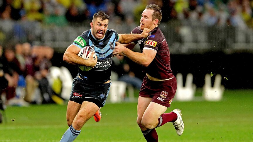 James Tedesco fends off Michael Morgan with the ball tucked under one arm