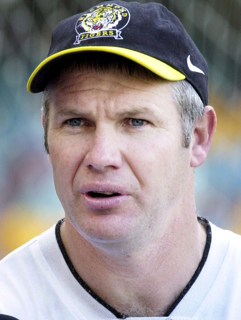 Danny Frawley, a clean-shaven white man,  wears a Richmond hat as he speaks to media in 2001.