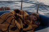 Woman sleeping on boat