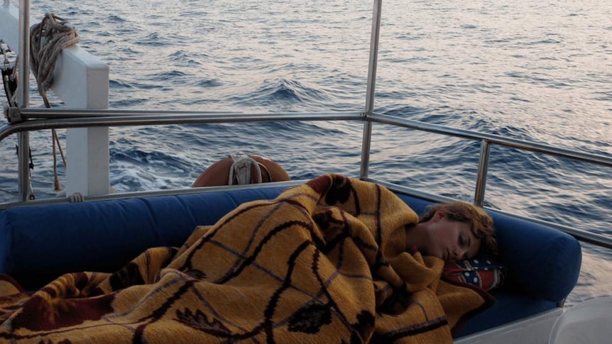Woman sleeping on boat