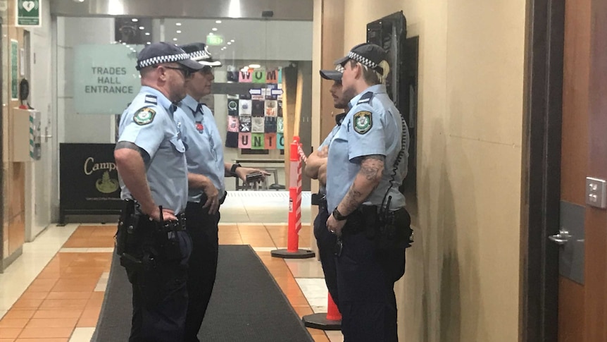 Police stand outside the offices of the Australian Workers' Union.
