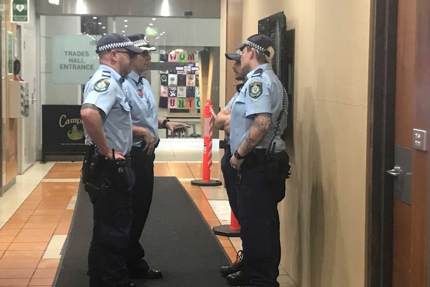 Police stand outside the offices of the Australian Workers' Union.