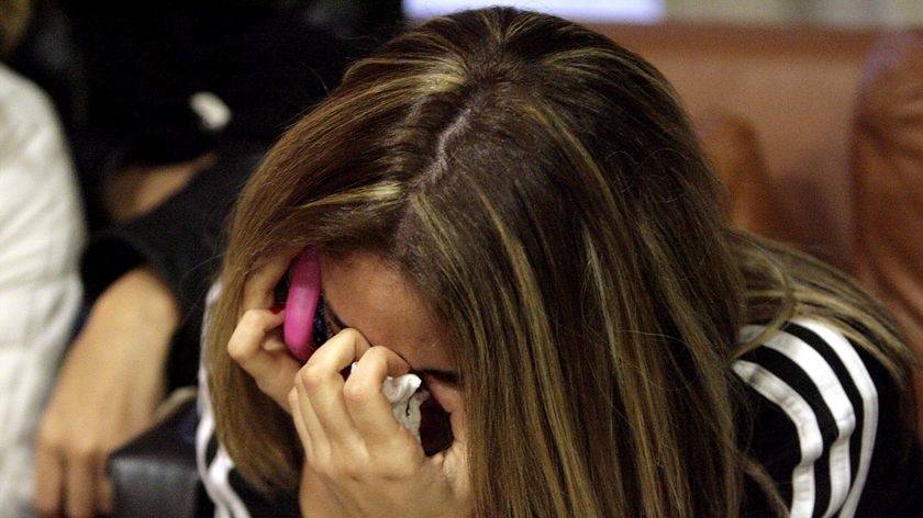 A Lebanese woman cries as she waits for news at the airport in Beirut