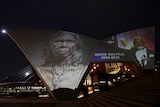 Sydney Opera House Bennelong Sails illuminated to show images of a David Gulpilil Ridjimiraril Dalaithngu.