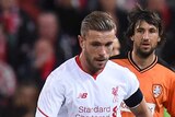 Spirited affair ... The Roar's Dimitrios Petratos (L) competes for the ball with Liverpool's Jordan Henderson