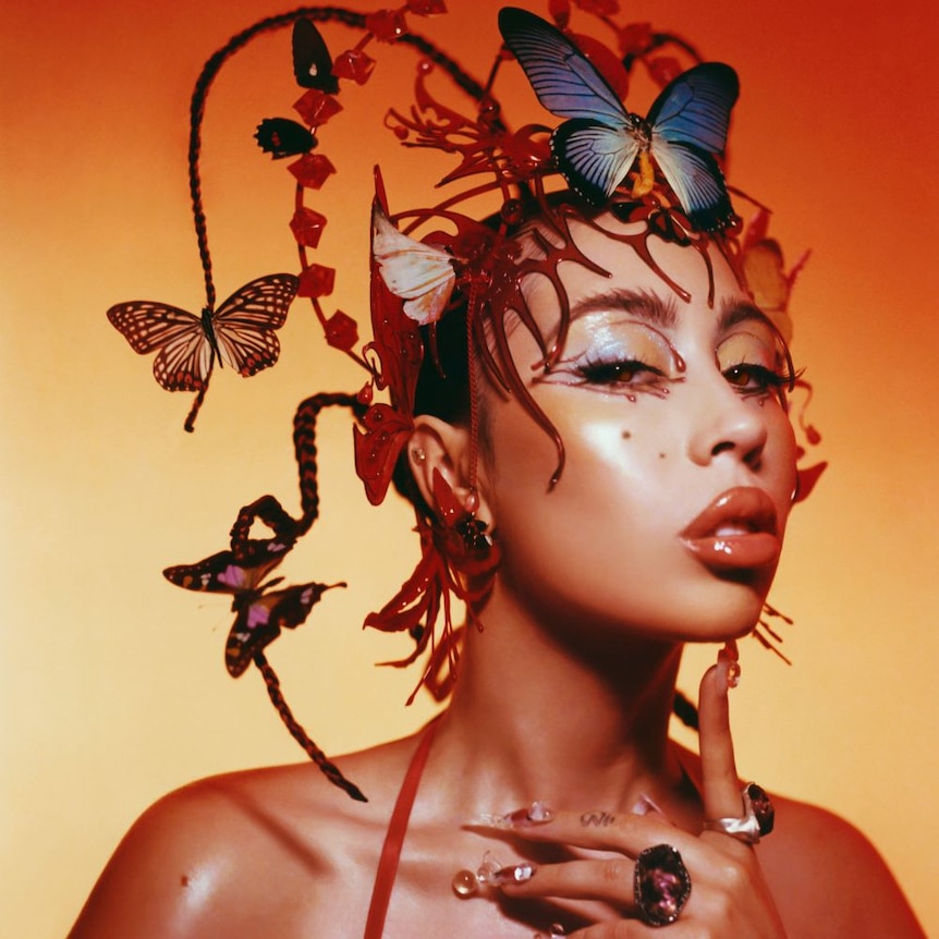  Photograph of Kali Uchis with butterflies in her hair.