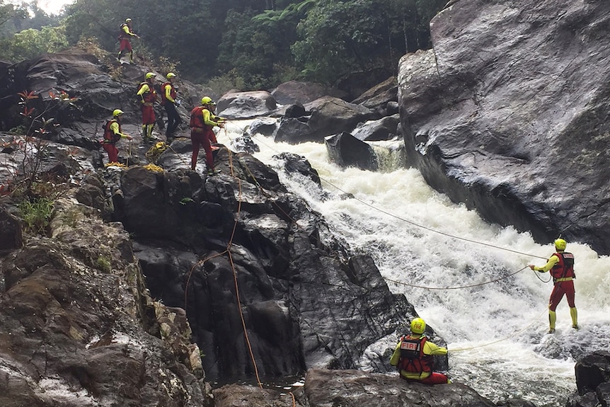 Emergency services at the scene of a waterfall where a kayaker was killed on the North Johnstone River.
