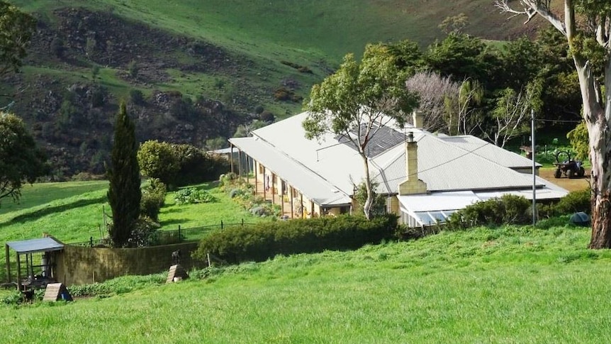 Mt Baines homestead perched on a hill amidst rolling green hills near Colebrook in Tasmania's south