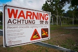 Sign warning for crocodiles in Peter Faust Lake in Proserpine, the sign has a don't swim notice on it and a picture of a croc