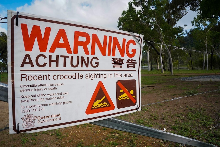 Sign warning for crocodiles in Peter Faust Lake in Proserpine, the sign has a don't swim notice on it and a picture of a croc