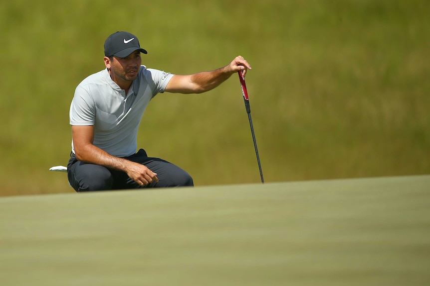 Jason Day looks over his putt on the 18th green during the second round of the US Open.