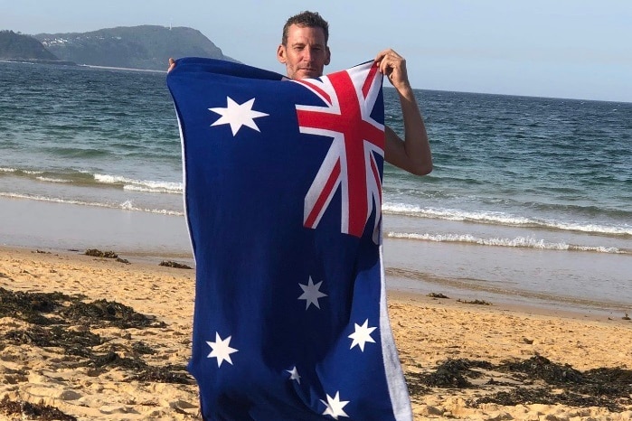 Man holding an Australian flag