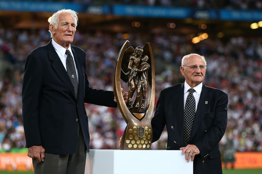 Norm Provan and Arthur Summons hold the NRL trophy that bears their name