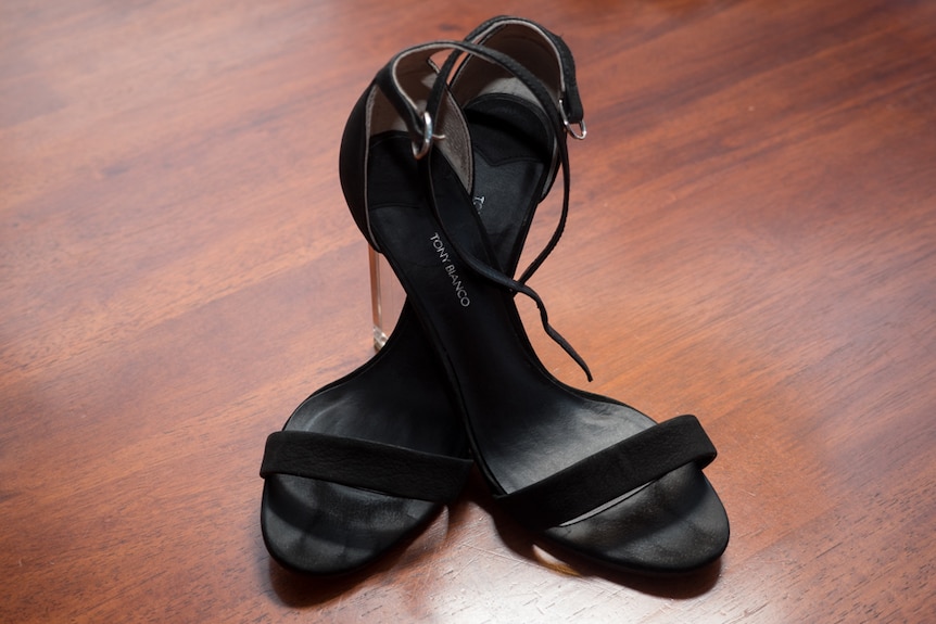A pair of Tony Bianco high-heeled shoes on a table.
