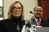 Kerry Kennedy speaks at a podium, in front of Martin Luther King III