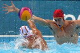 Water polo goalkeeper James Clark tries to save against Spain