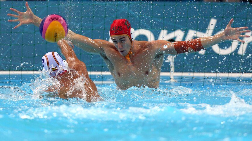 Water polo goalkeeper James Clark tries to save against Spain