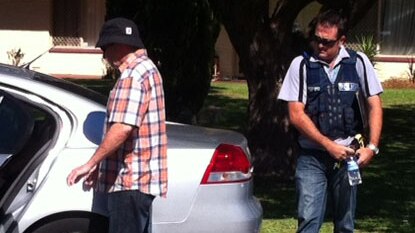 Alleged fraudster escorted by WA police