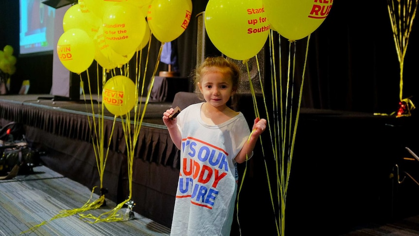 A girl holds some balloons at Kevin Rudd's election event.