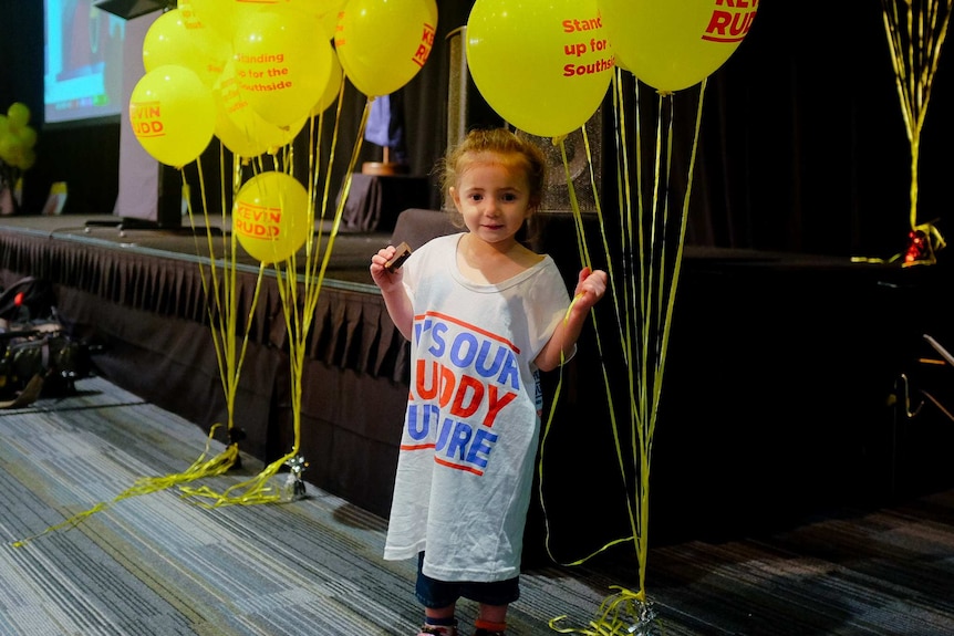 A girl holds some balloons at Kevin Rudd's election event.