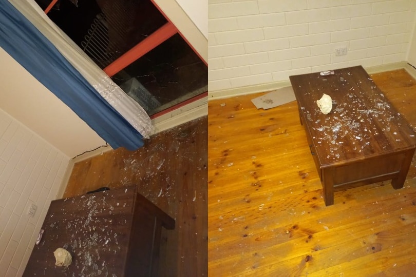 Two images show a rock inside a lounge room with broken glass all over the floor.