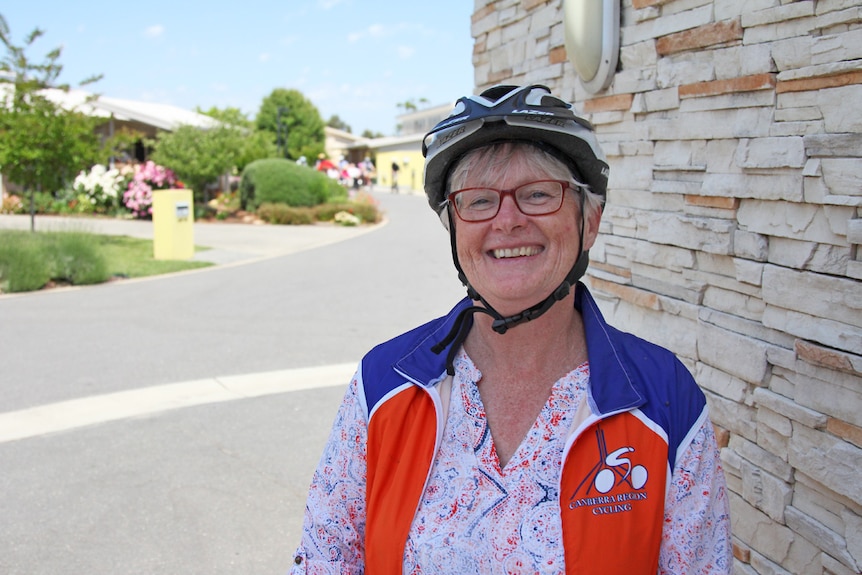 Lady wearing a bike helmet.