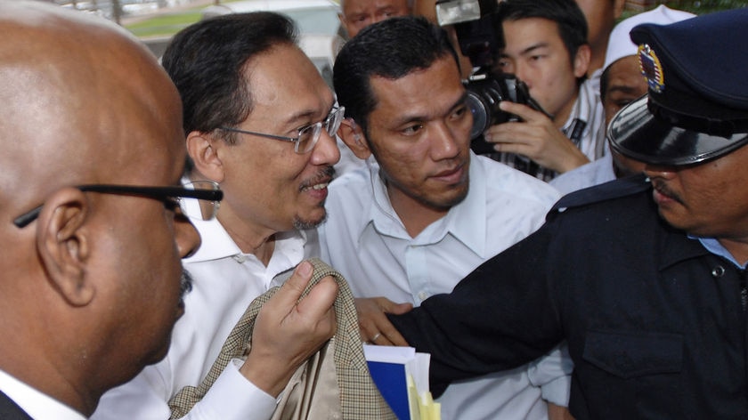 Malaysia's de facto opposition leader Anwar Ibrahim is led by police