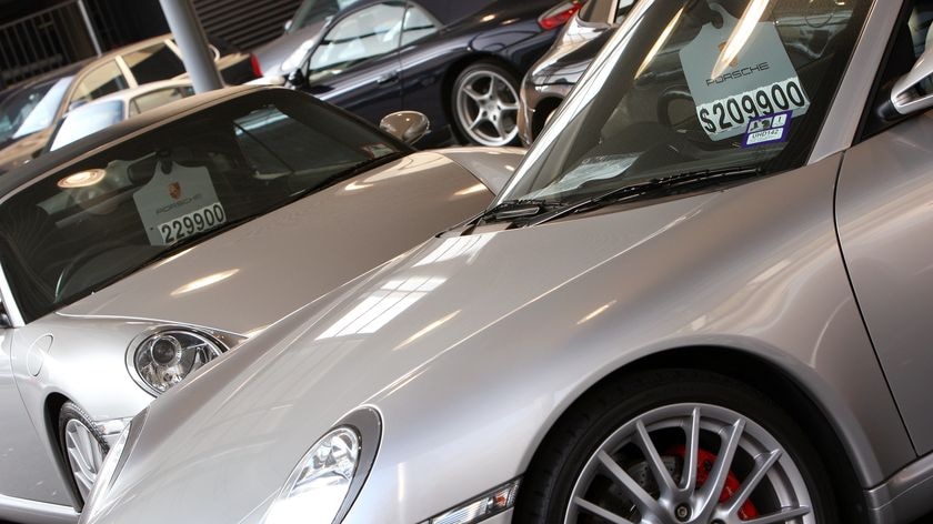 A row of Porsche cars are lined up