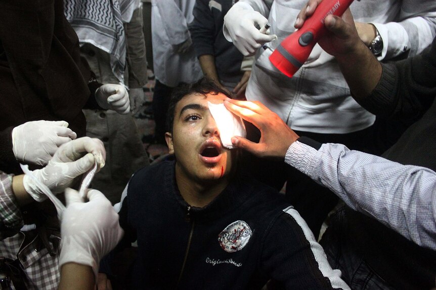 An Egyptian protester wounded in the eye is treated at a field hospital.