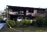 A burnt-out house and cars at Slacks Creek