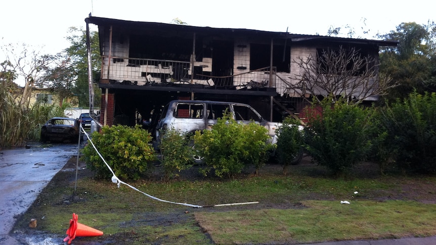 A burnt-out house and cars at Slacks Creek