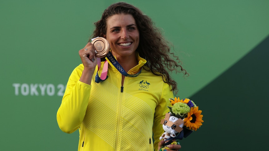 An Australian female kayaker shows off her bronze medal at the Tokyo Olympics.