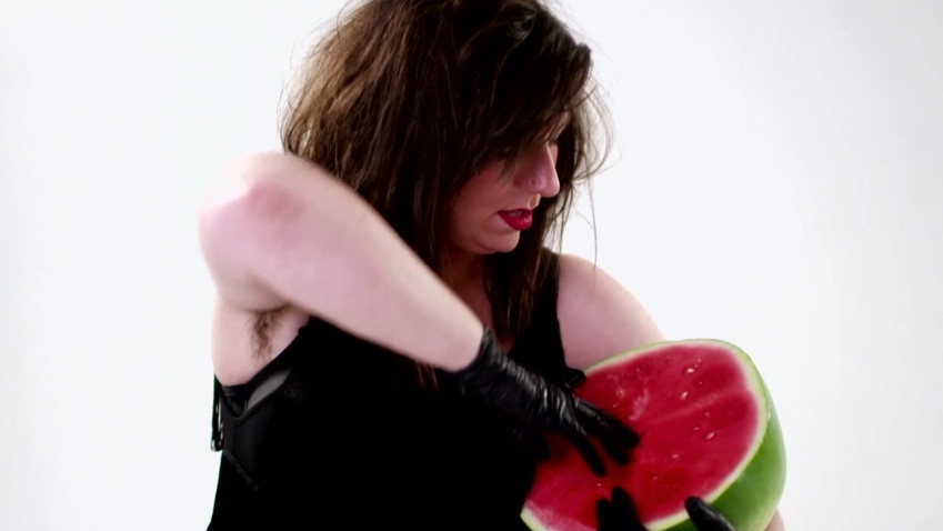 A woman holds a watermelon in a new sexual health music video for ACON's women's project, Claude.
