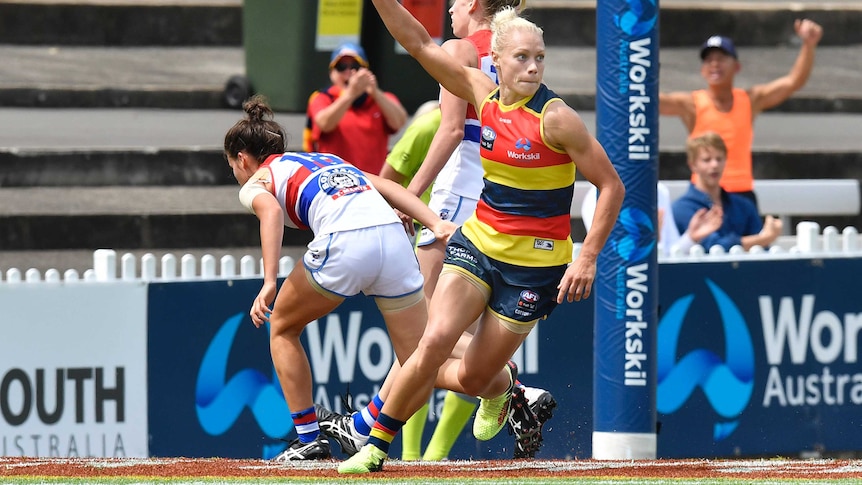 Adelaide's Erin Phillips (R) reacts after a goal against Western Bulldogs at Norwood Oval in AFLW.