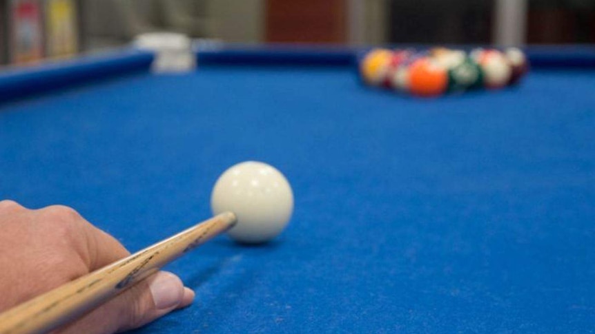 A man playing pool at the County Court of Victoria