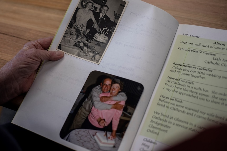Cheryl Weily looks through an album with photos of her father Richard.